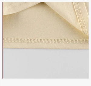 Macro view of high-quality knit cotton hem with neat double-needle stitching detail