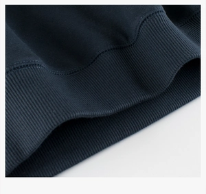 Detailed view of the dark blue ribbed cuff on a warm fleece-lined sweatshirt