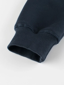 Detail of navy blue fleece hoodie sleeve with ribbed cuff and quality stitching