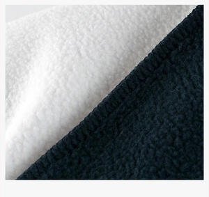 Macro shot of high-density navy polar fleece with white sherpa lining and neat stitching