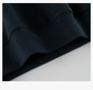 Close-up of deep blue ribbed hem and stitching details on boys' fleece sweatshirt