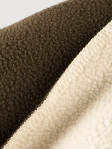 Gros plan sur un tissu polaire sherpa épais marron et crème pour sweat enfant