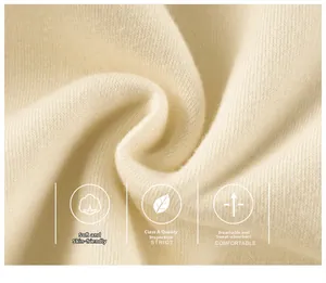 Macro detail of soft cream-colored fleece fabric showing high-quality knitted texture