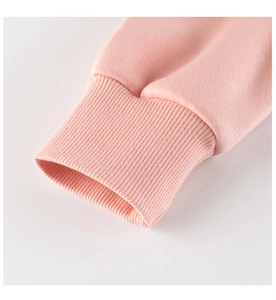 Detail of ribbed cuffs on a light pink girls' cartoon sweatshirt with knit texture