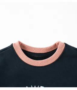 Detail of navy blue fleece sweatshirt featuring contrast pink ribbed crew neck and embroidery