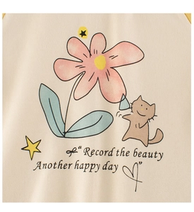Detail of beige cotton knit fabric featuring cute floral cat prints and English text