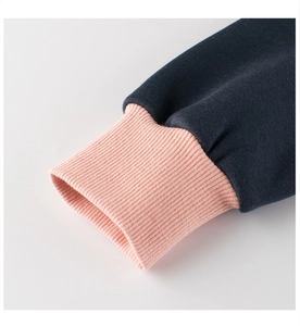 Detail of ribbed cuffs on a navy blue and pink patchwork fleece sweatshirt for girls