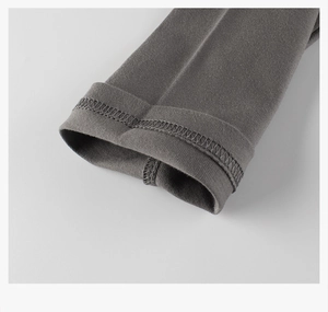 Detail of double-needle stitching on dark grey knit cotton sleeves of children's t-shirt