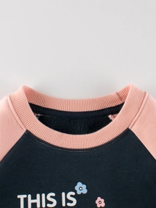 Girl's fleece-lined sweatshirt with navy floral print and pink raglan sleeves