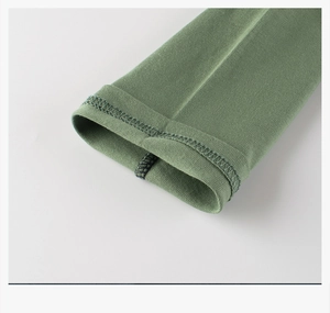 Detail of double-needle stitched cuff on children's green knit raglan long sleeve t-shirt