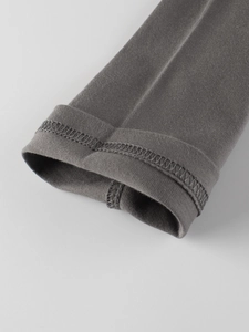 Detail of dark grey knit cotton sleeve cuff with double-needle stitching on kids' shirt