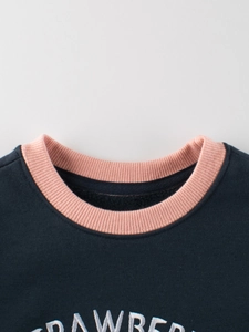 Navy blue kids fleece sweatshirt with pink ribbed collar and strawberry lettering
