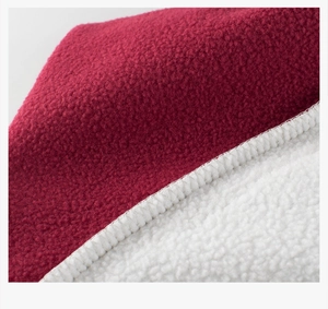 Macro detail of wine red polar fleece bonded with soft white sherpa lining material