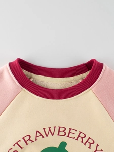 Kids fleece strawberry sweatshirt with pink raglan sleeves and cream-colored body