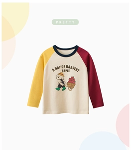 Detail of children's raglan sleeve T-shirt featuring a cartoon dog harvest apple print