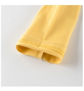 Detail shot of soft yellow knitted cotton cuff showing precise double stitching quality
