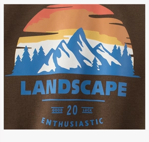 Detail of outdoor landscape print on dark brown fleece hoodie with snowy mountain graphic
