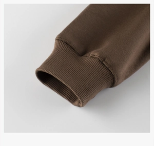 Close-up of brown children's fleece sweatshirt with high-quality ribbed cuffs detailing