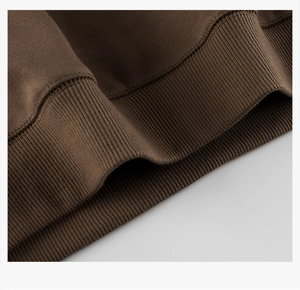 Close-up of the ribbed cuff and hem on a warm dark brown fleece-lined boys' sweatshirt