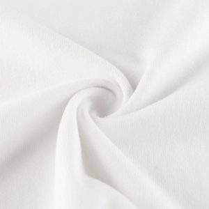 Macro shot of white knitted fabric texture showing soft cotton weave and fine stitching