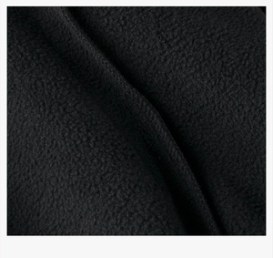 Macro view of thick black polar fleece fabric with soft and warm textured fleece material