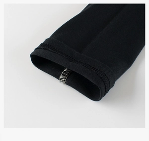 Close-up detail of reinforced overlock stitching on black cotton long sleeve shirt cuff