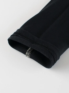 Detail of premium double-stitched cuffs on black long-sleeve cotton T-shirt for kids