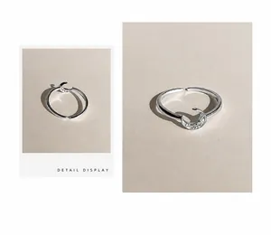 Detailed macro view of moon-shaped ring featuring sparkling micro-pave cubic zirconia crystals