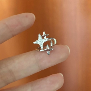 Detailed view of silver star ear cuff with sparkling zircon and minimalist wrap design