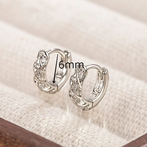 Detail of 6mm silver twist hoop earrings with pavé cubic zirconia on a beige display