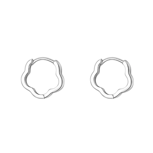 Macro shot of silver flower hoop earrings with minimalist metal design on white backdrop