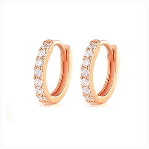 Close-up of rose gold hoop earrings with sparkling white crystals on white background