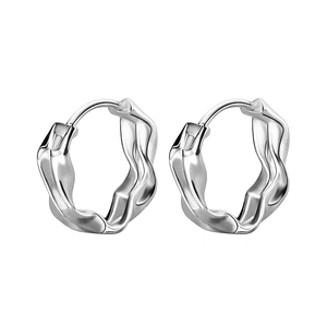 Detail showing irregular wavy silver hoop earrings with a polished fluid texture