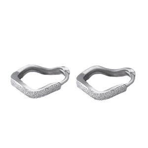 Close-up of wave-shaped heart hoop earrings with silver frosted and polished finish