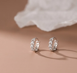 Macro shot of silver heart shaped earrings with sparkling pavé cubic zirconia