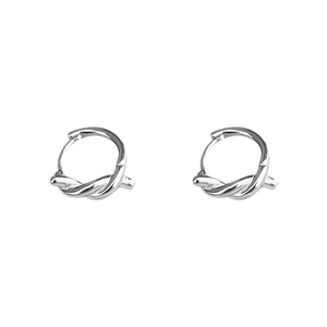 Close-up of silver twist hoop earrings with polished metal texture and minimalist design