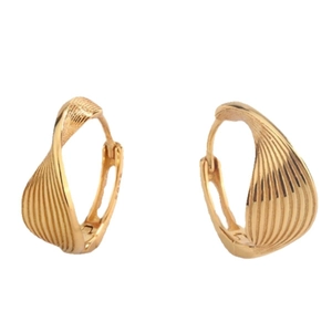 Macro detail of gold-plated twisted hoop earrings with embossed wavy texture