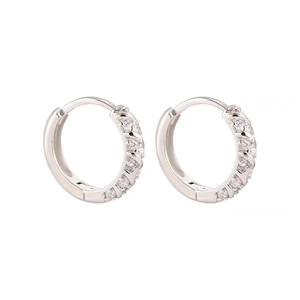 Macro detail of silver hoop earrings featuring two rows of sparkling cubic zirconia stones