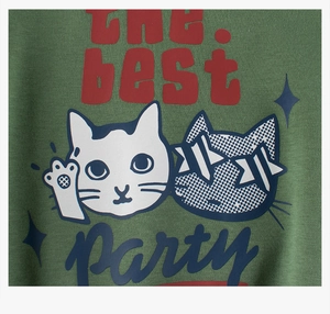 Detail of green fleece sweatshirt showing cute cartoon cats and THE best PARTY print