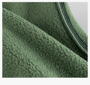 Macro view of dark green sherpa fleece texture and detailed stitching on kids hoodie