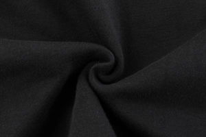Detailed close-up of premium black fleece knit fabric showing thick cotton texture