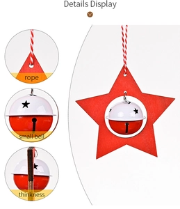 Detail view of red wooden star ornament with two-tone metal bell and braided rope