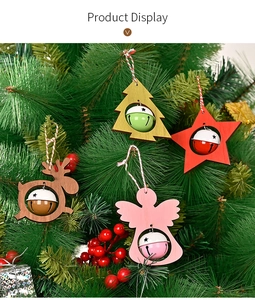 Detailed view of non-woven Christmas ornaments with bells hanging on a festive tree branch