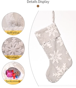 Detail view of grey plush Christmas stocking with snowflake patterns and hanging rope