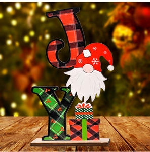 Close-up of wooden JOY sign with Christmas gnome and red buffalo plaid patterns