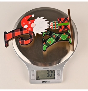 Detailed view of Rudolf wooden Christmas ornament on a scale showing 30.7g weight
