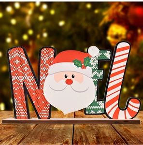 Macro detail of NOEL wooden Christmas ornament with Santa Claus and festive patterns
