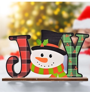 Detail of wooden JOY sign featuring plaid patterns and a cute snowman for Christmas