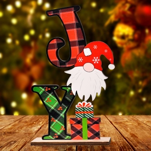 Christmas wooden JOY sign with gnome and plaid pattern on a cozy tabletop