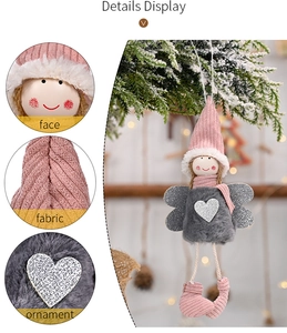 Detail display of pink plush Christmas angel ornament with silver wings and knit fabric